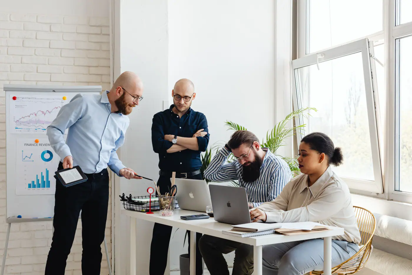 A software team discussing work beside a planning board