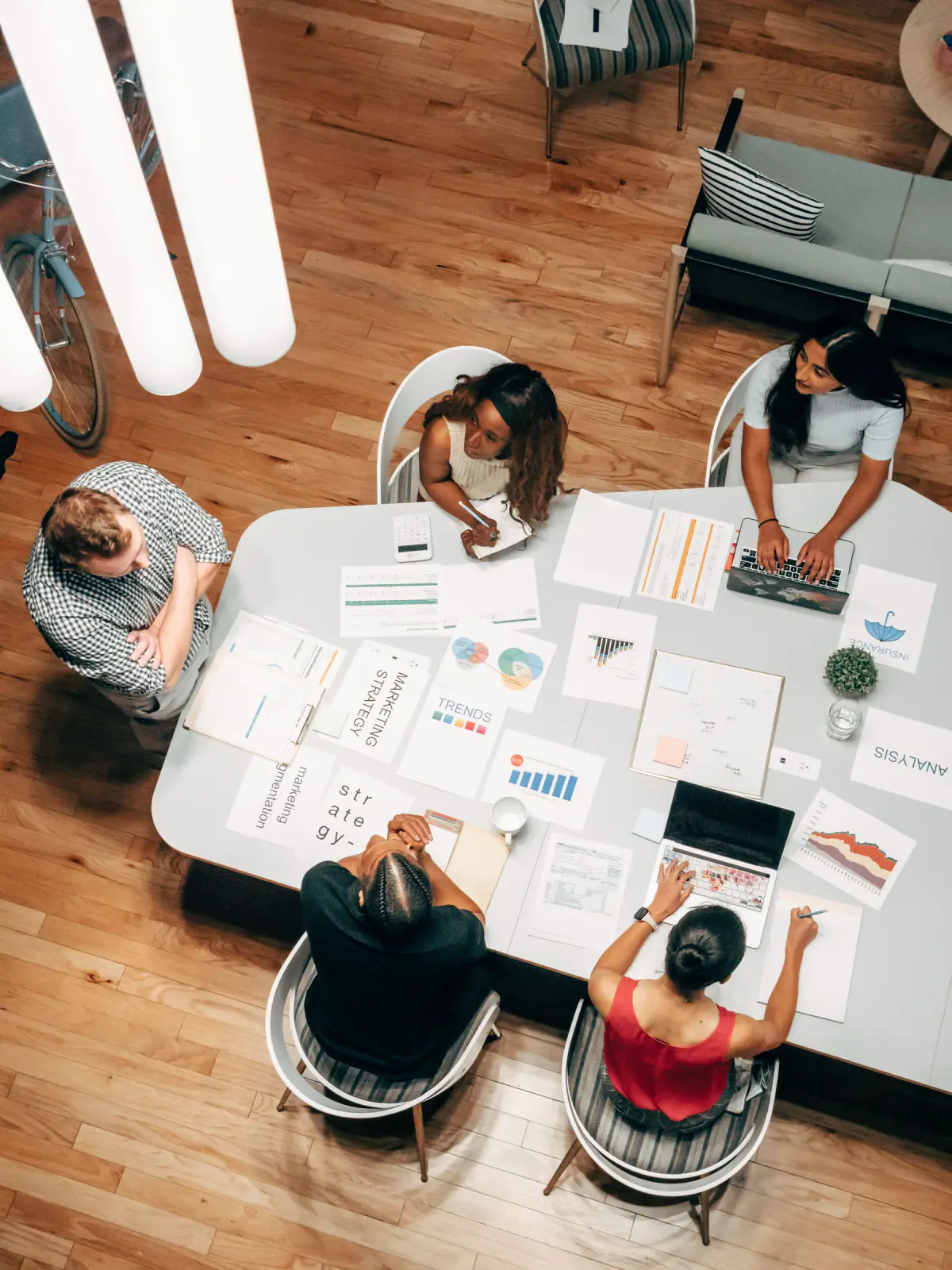 A team reviewing plans and business data around a shared table